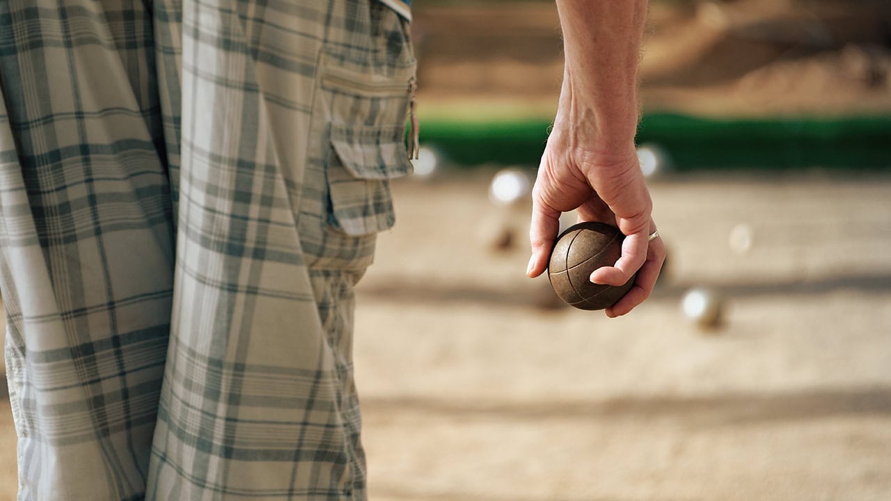 Senior man playing petanque bocce Image produced by More Jersey.