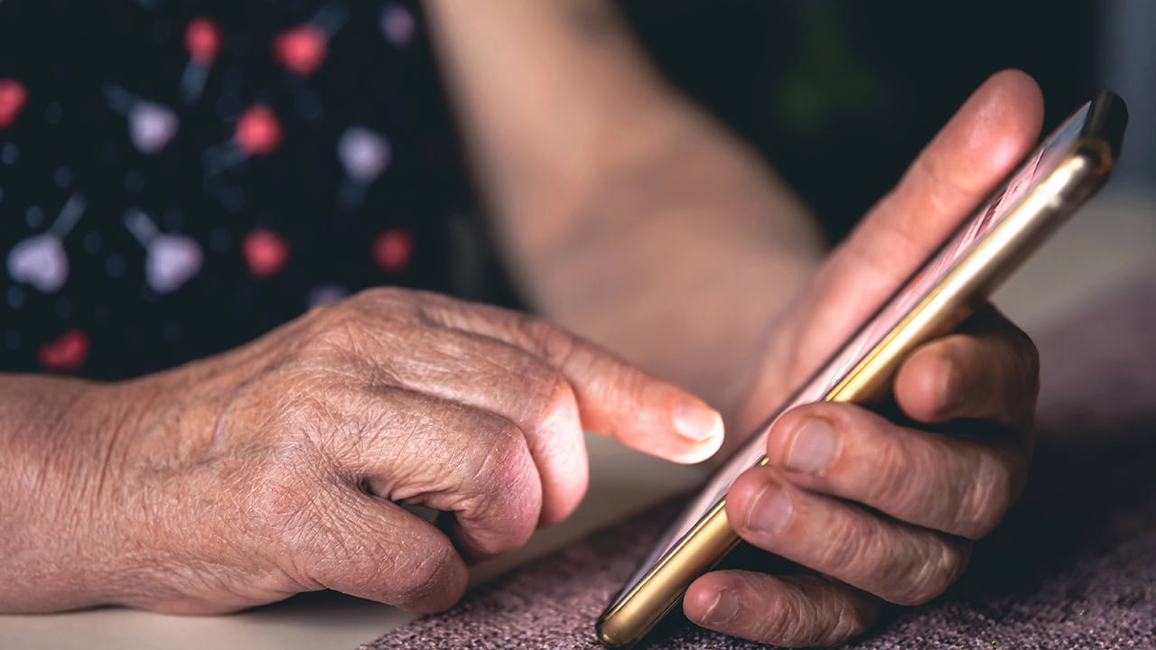 Senior woman using smartphone. Image produced by More Jersey.