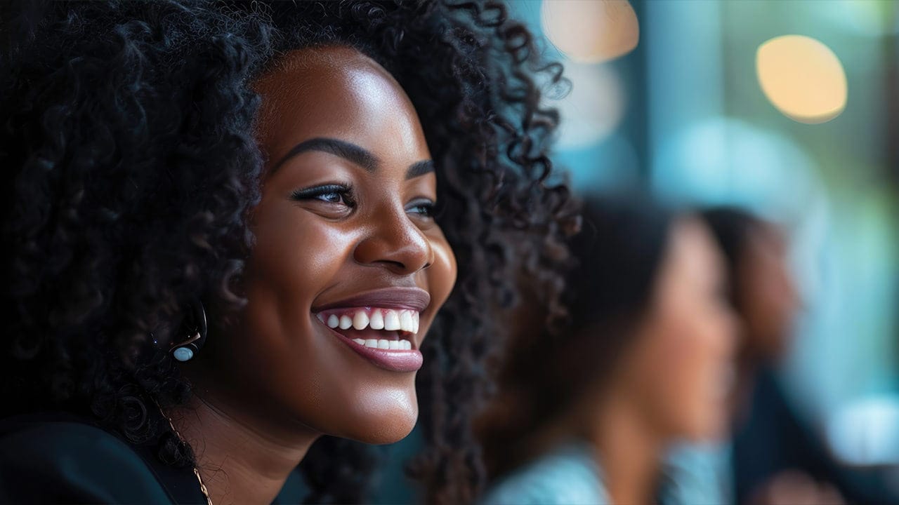 Smiling African American woman at a professional development event.