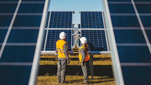 Solar panel technicians at New Jersey solar panel power plant.