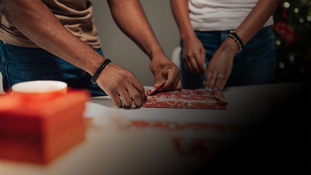 Two residents wrapping gifts at New Jersey Gift Wrapping Social.