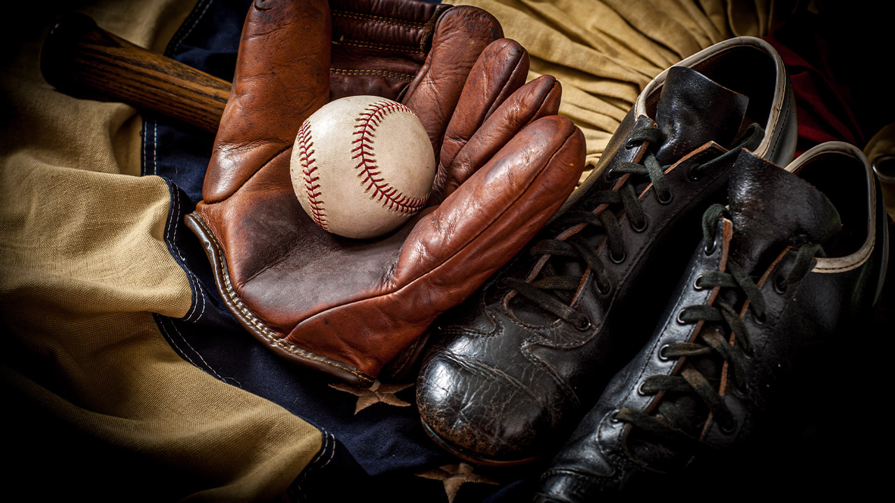 Vintage baseball glove, ball, and cleats.
