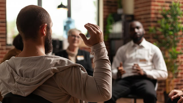 White male resident sharing his mental health issues during group therapy meeting.