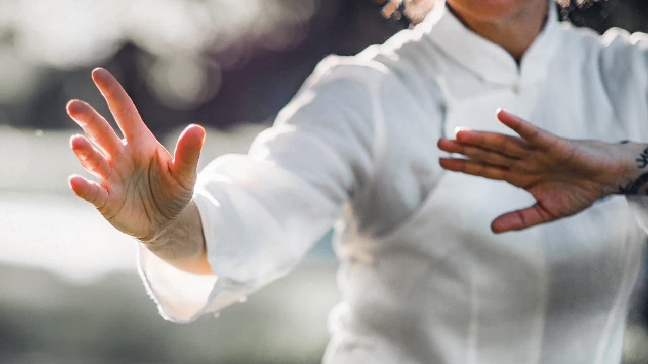 Woman practicing Tai Chi and Qi Gong exercises.
