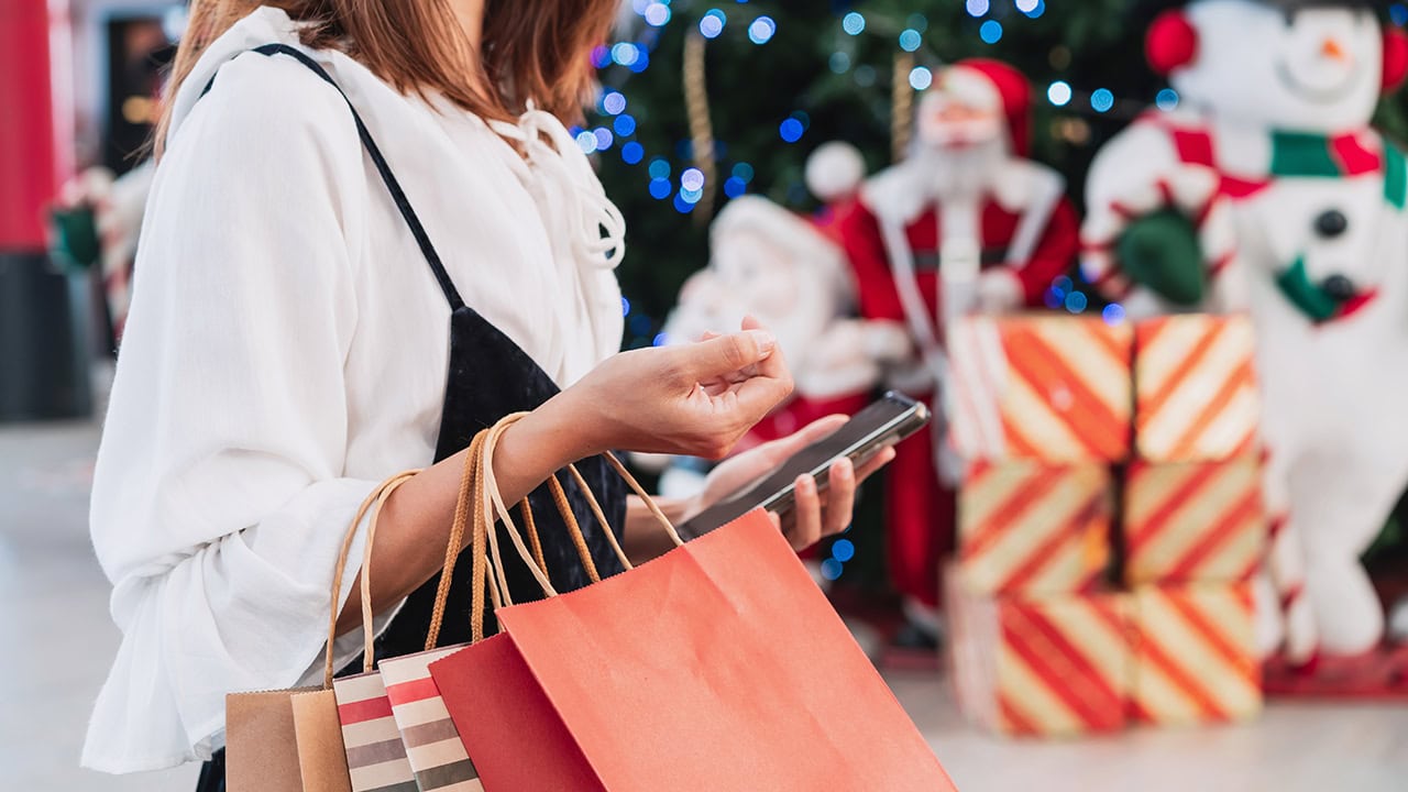 Woman with shopping bags at New Jersey Christmas holiday marketplace. Image produced by More Jersey.