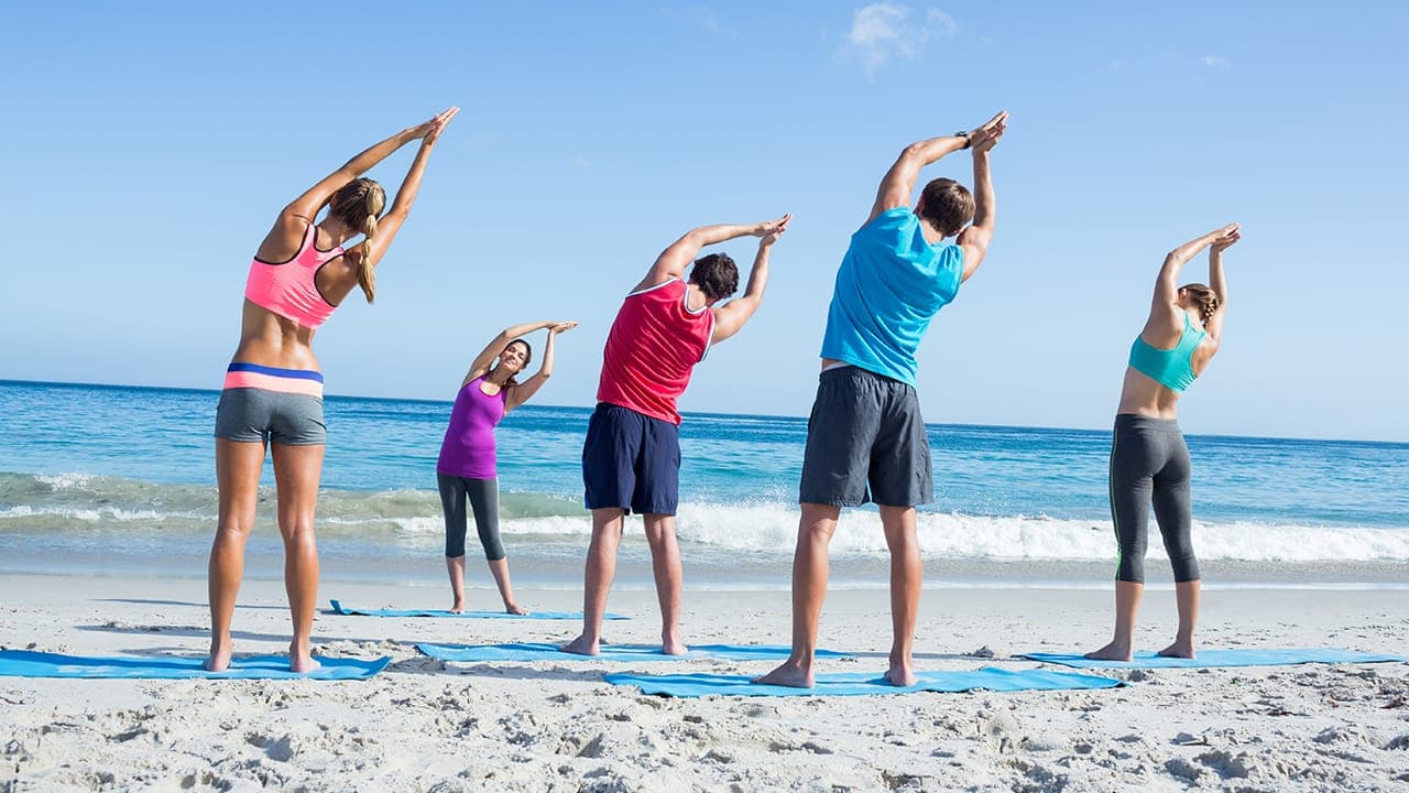 Yoga class held outdoors at New Jersey beach. Image produced by More Jersey.