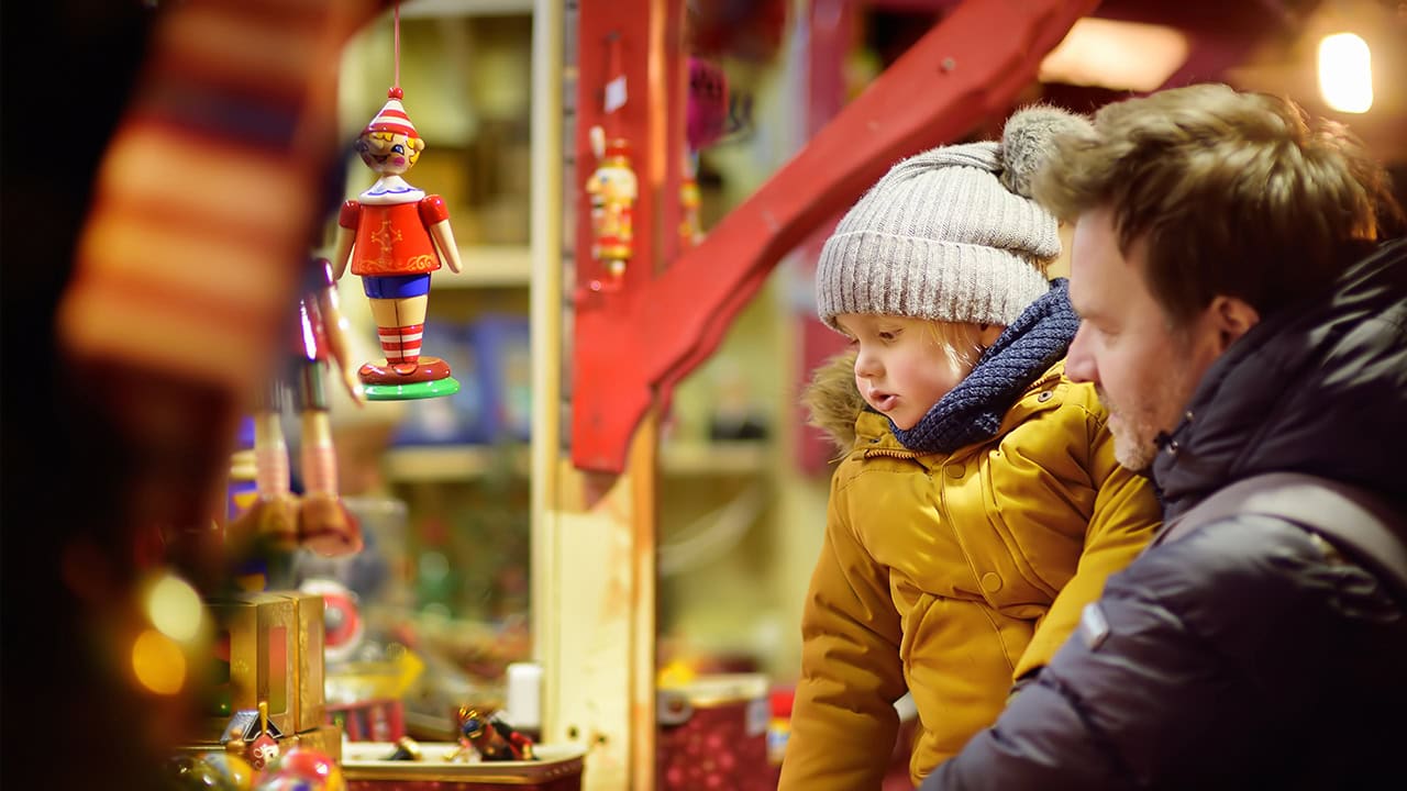 Young boy and father at outdoor holiday market booth. Image produced by More Jersey.